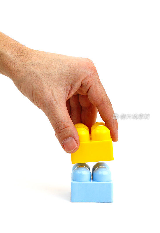 Hand is buildings with toy bricks